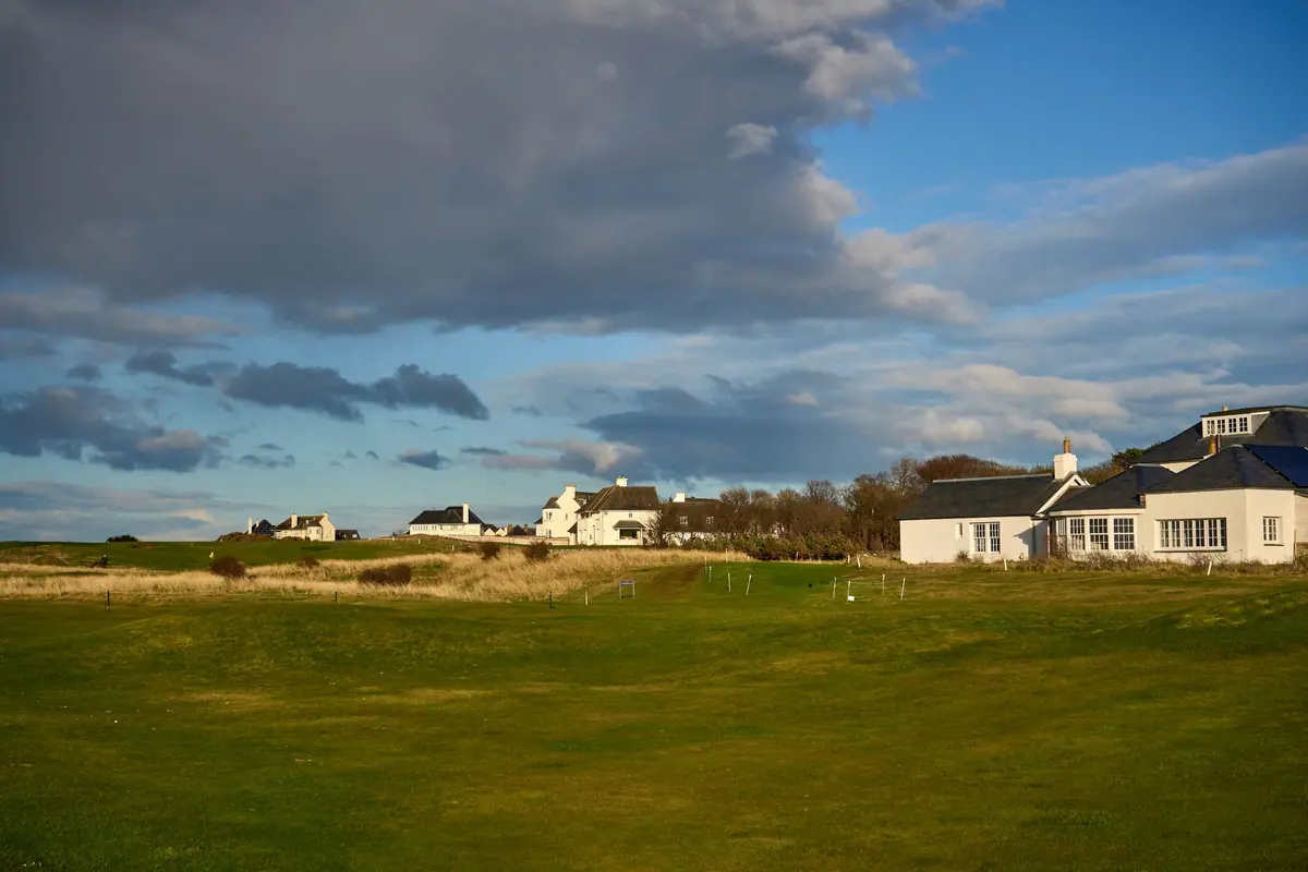 A golf clubhouse beyond the eighteenth green